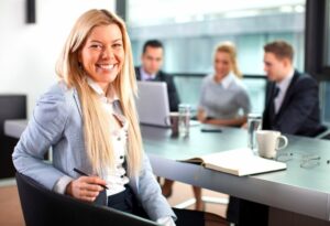 woman in office attire smiling at camera
