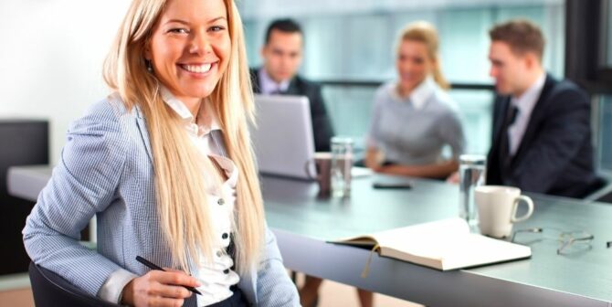 woman in office attire smiling at camera